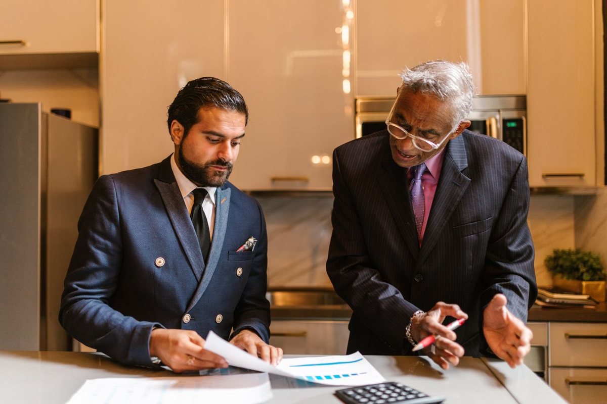 An advisor and client discussing financial plans at a table