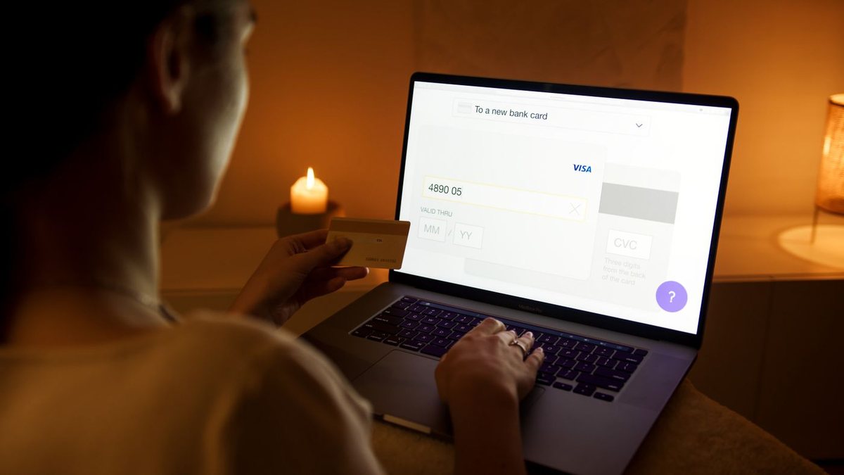 Person using a laptop at home in warm evening light