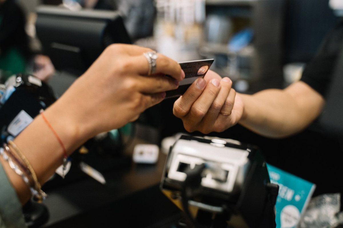 Close-up of a payment card being presented at a cafe