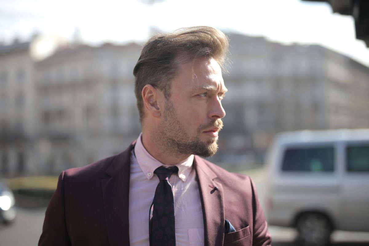 Professional in a tailored suit standing on a city street