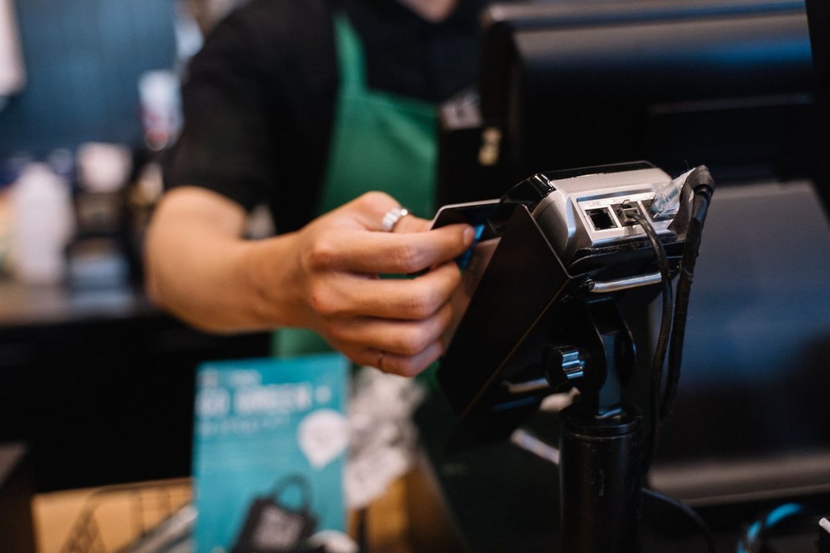 Cafe worker accepting a customer's card payment