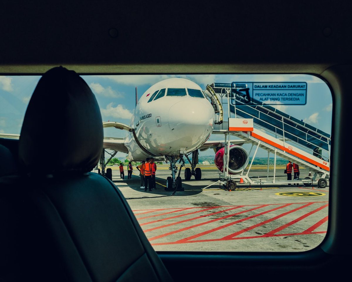 Airplane waiting at an airport viewed through a window