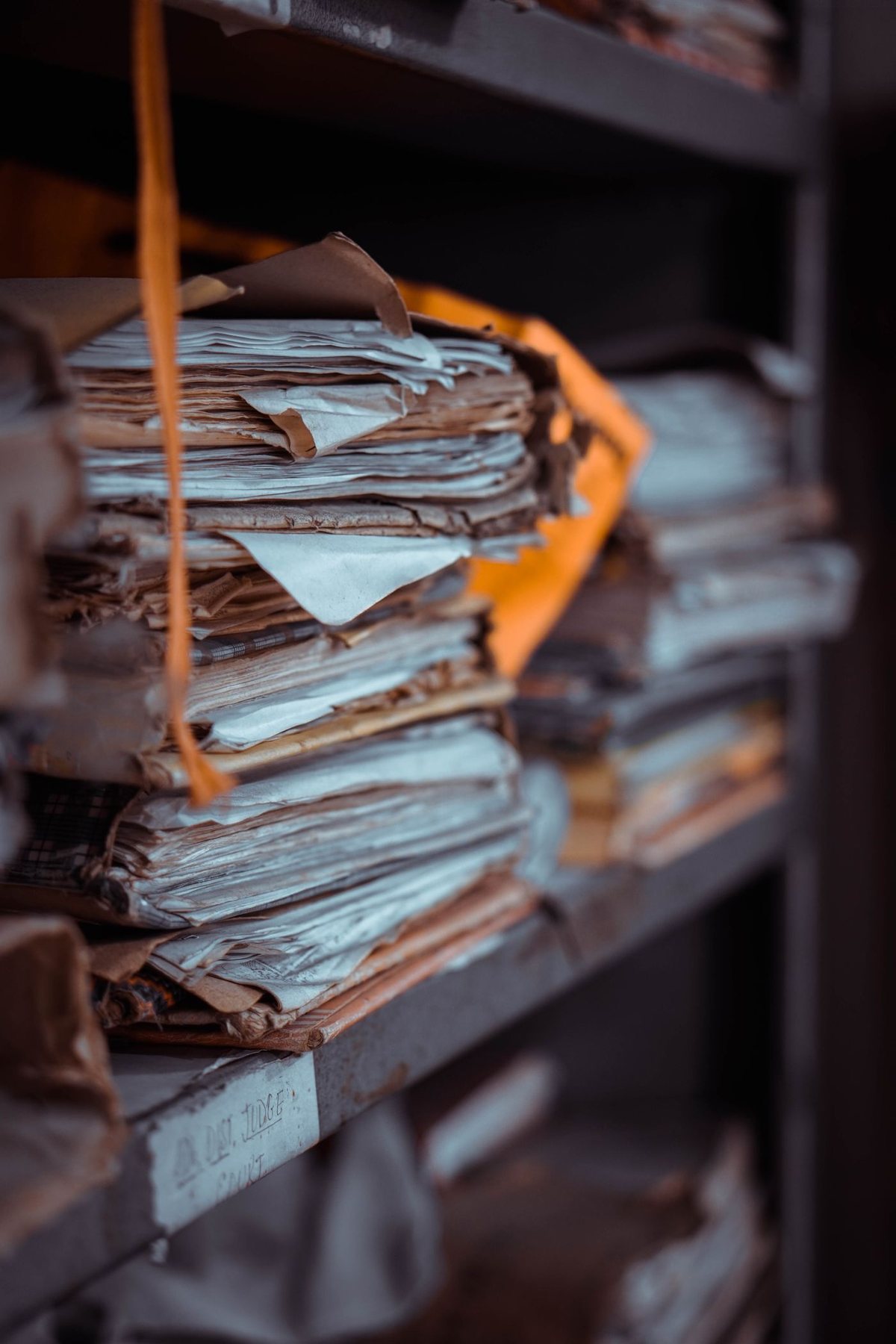 Paper records securely tied and organized on shelves